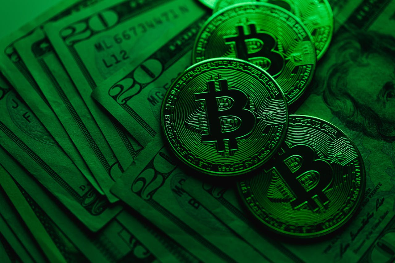 our-experience Close-up of Bitcoin coins on US dollar bills, showcasing cryptocurrency's value.