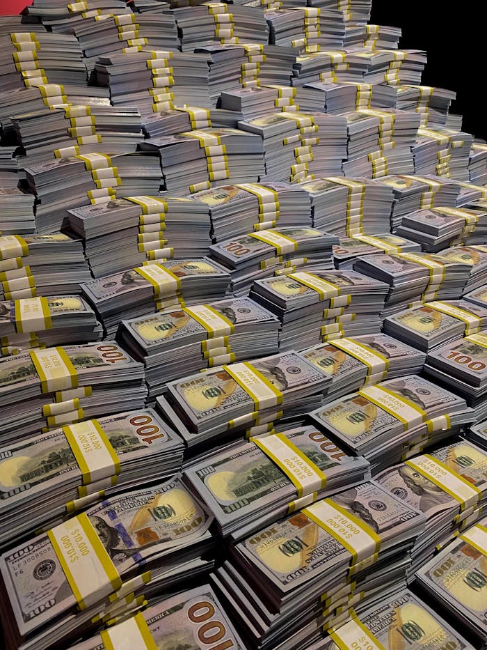 Large piles of 100 US dollar bills neatly stacked, symbolizing wealth and financial abundance.