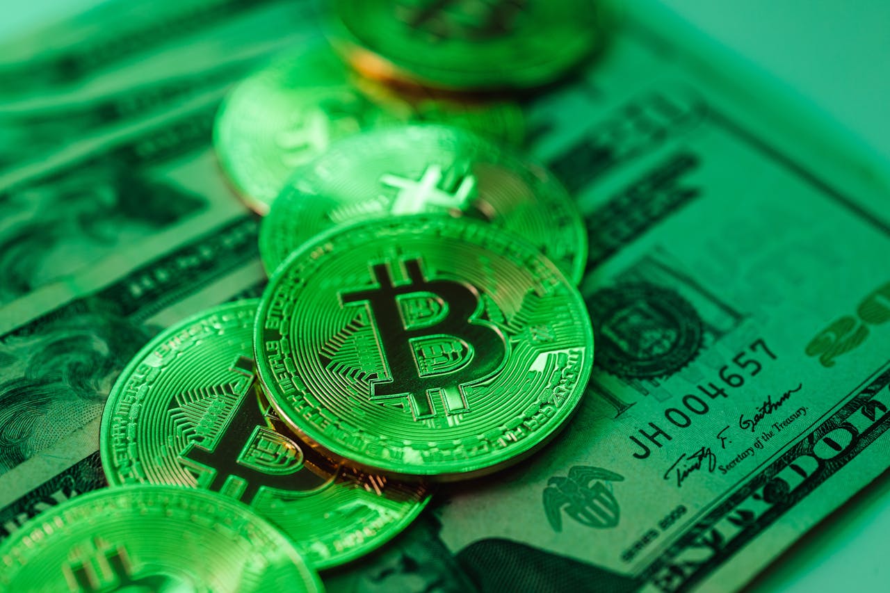 Vivid green Bitcoin coins stacked on American dollar bills symbolizing cryptocurrency investment.